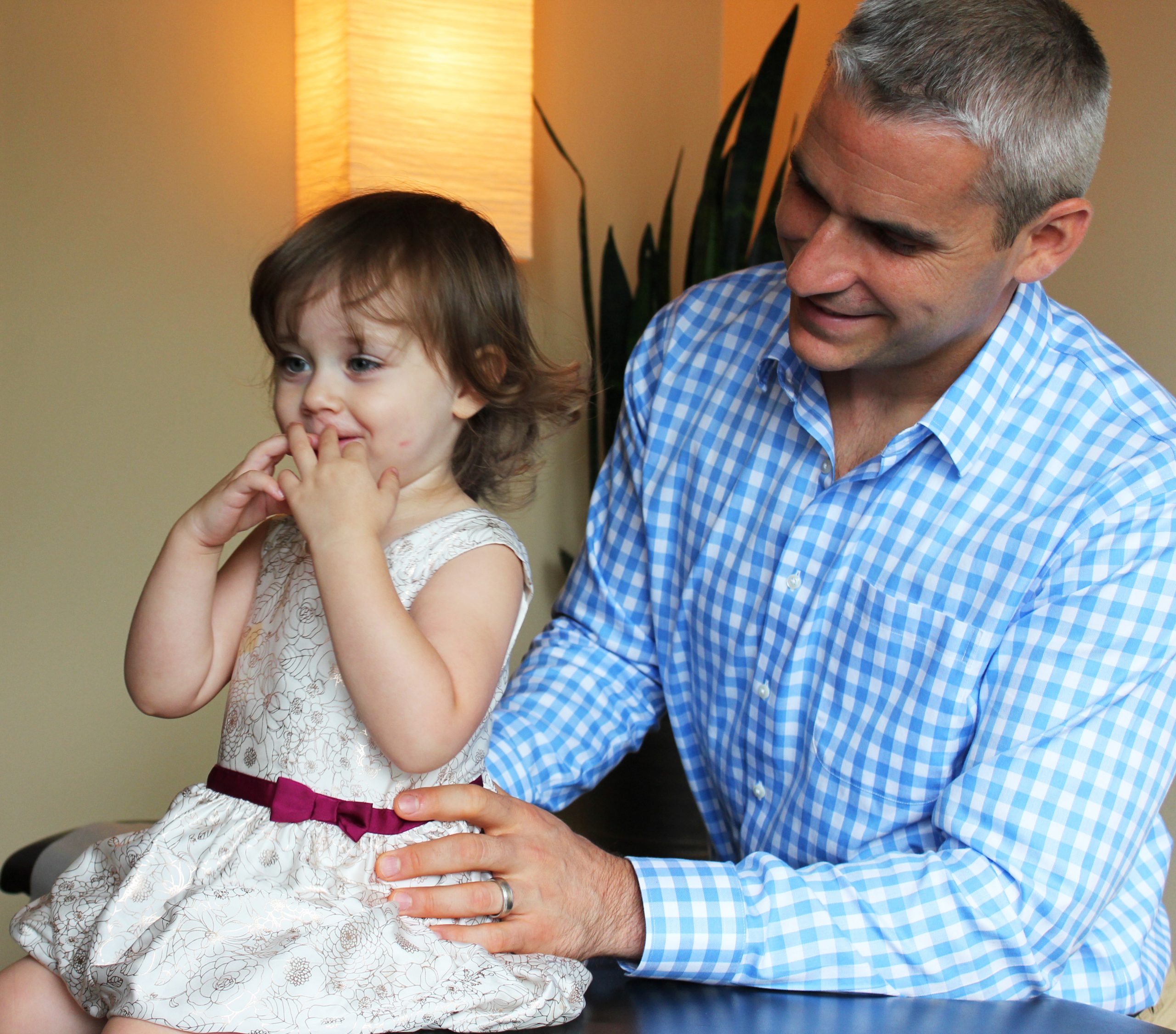 Dr. Noya adjusting toddler