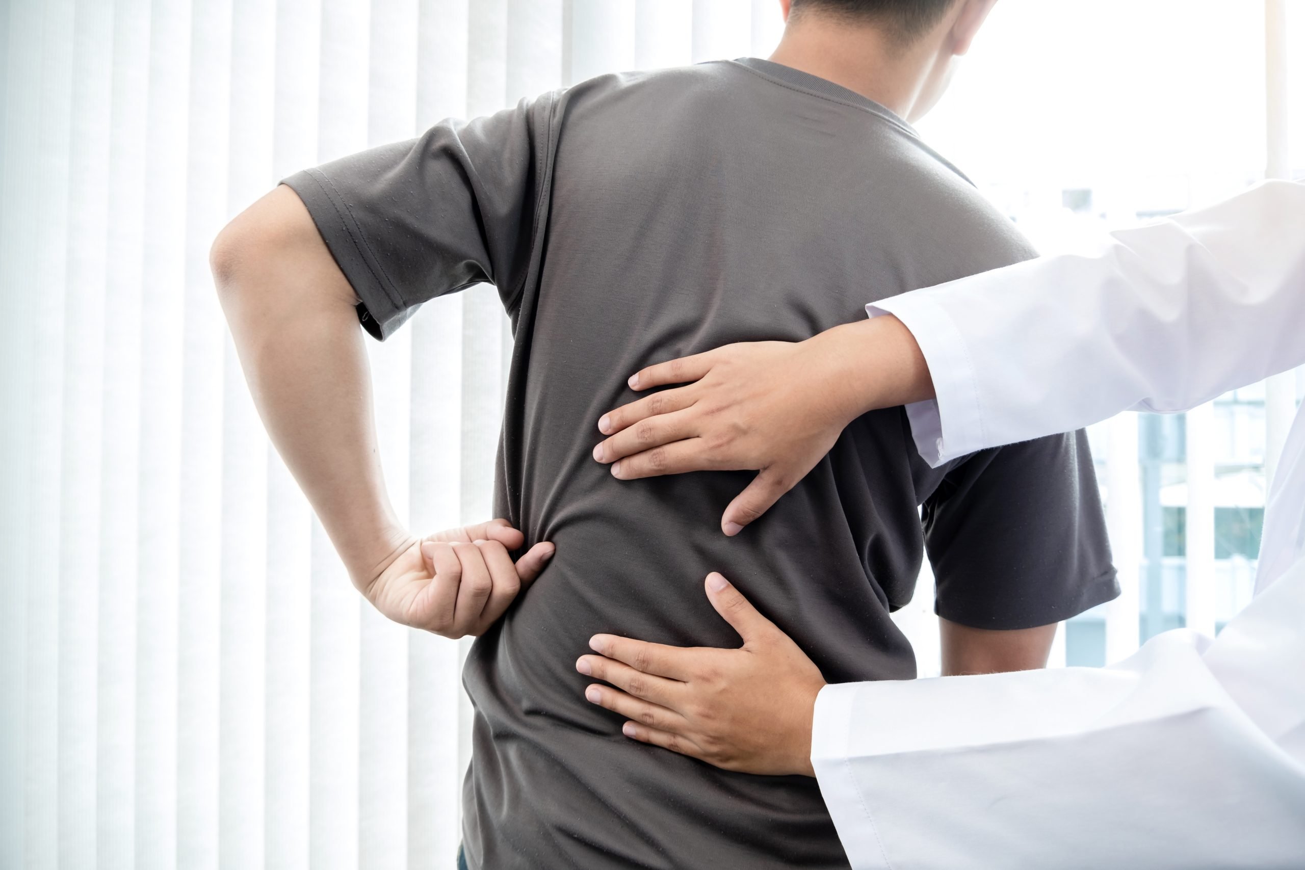 A woman has her back pain adjusted by a chiropractor in Washington, DC